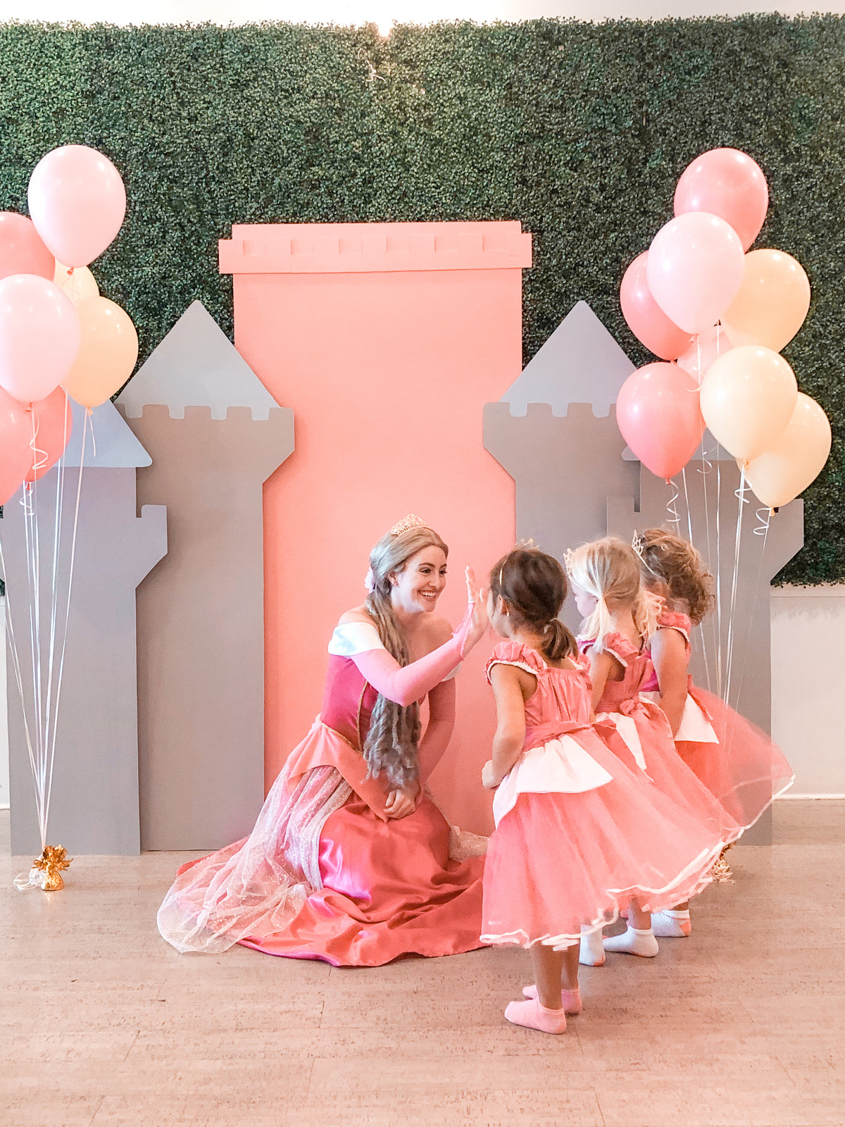 Sleeping Beauty posing with kids in front of a backdrop at Water Lemon