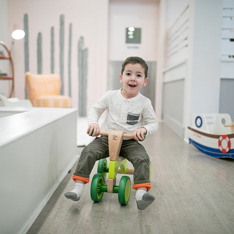 A child riding a bike inside 