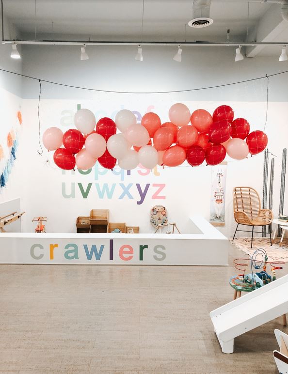 A balloon garland hanging above the crawlers space at Waterlemon kids