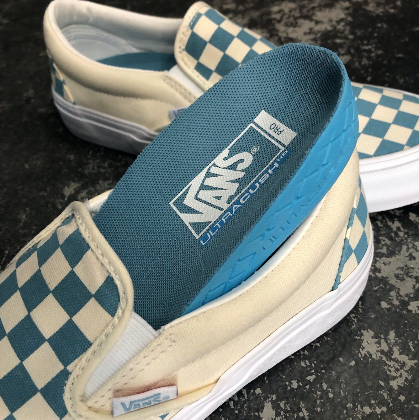 teal checkerboard slip on vans