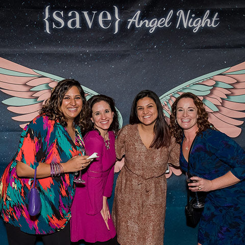 4 ladies in front of wings backdrop at Angel Night on Instagram