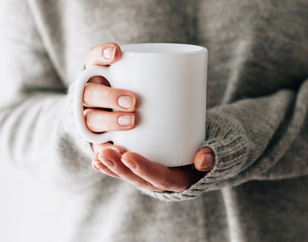 Hands Holding Cup of Tea | Marijuana Packaging