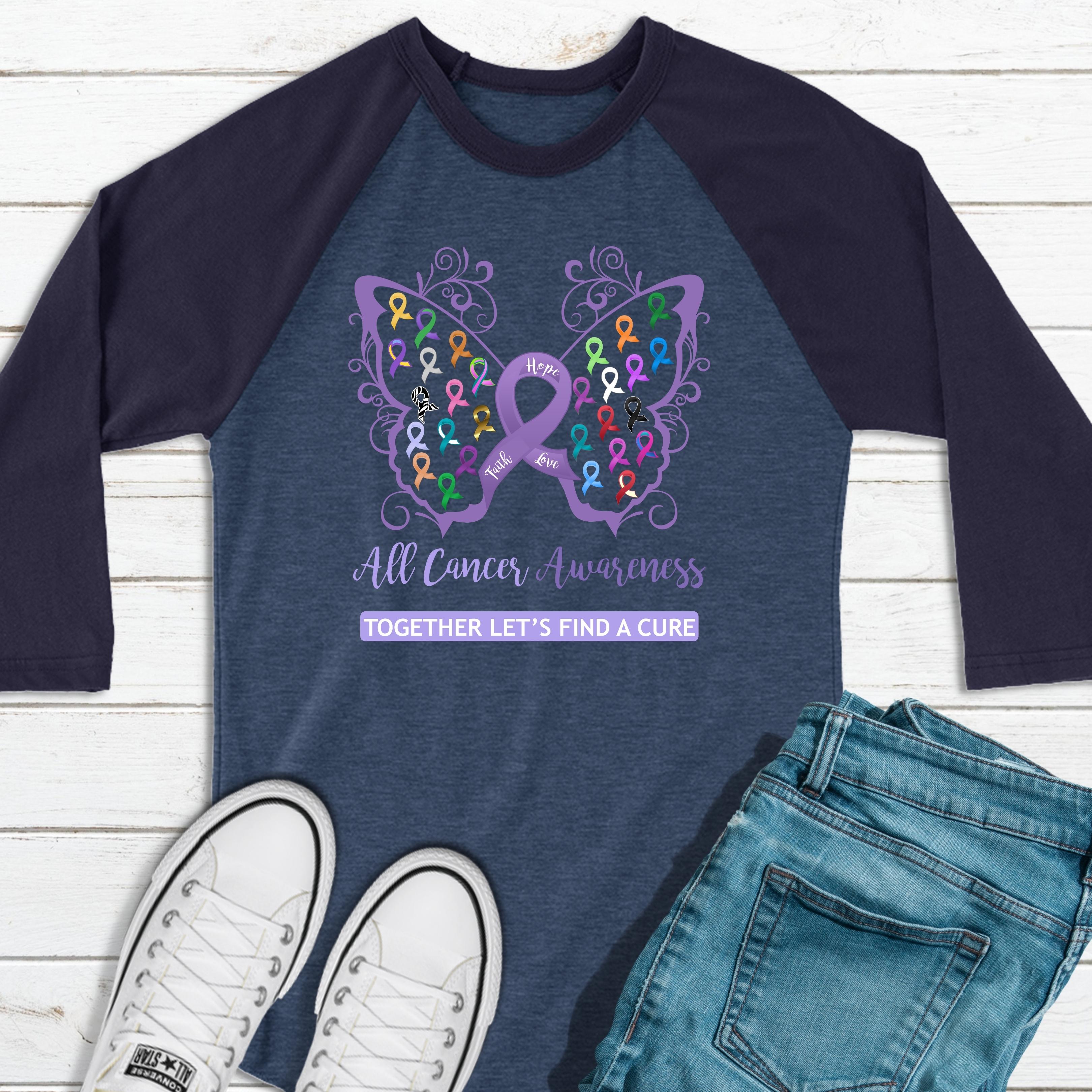 https://cdn.shopify.com/s/files/1/0039/1013/9974/products/AllCancerAwarenessFiligreeButterflyDenimBlue34SleeveRaglanTee.jpg?v=1665265992