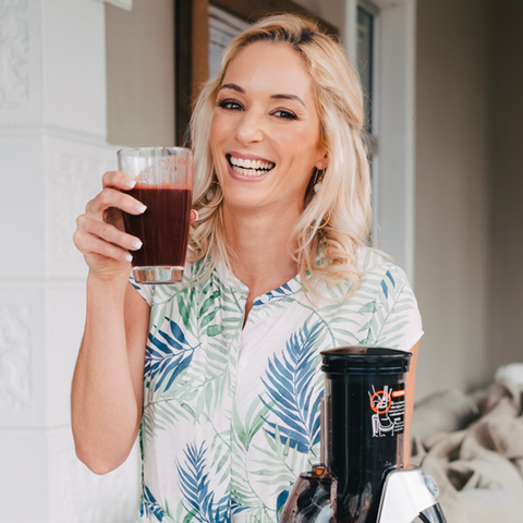 Lisa Raleigh drinking veggie juice with cold press juicer