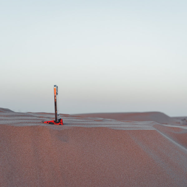 A tripod holding an iphone in the desert 