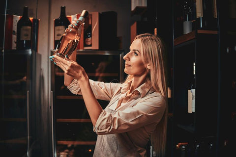 A women is storing red wine