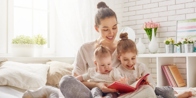 Mother reading to two young girls