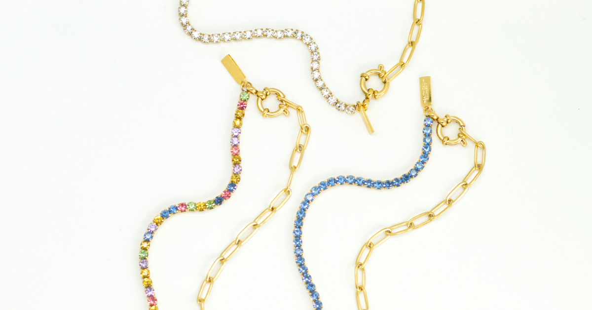 multiple tennis necklaces with different colored jewels