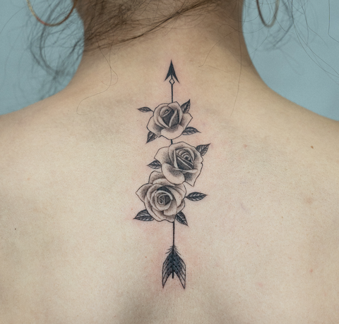rose tattoo on neck with arrows