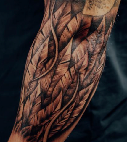 Feather tattoo black and grey realism arm