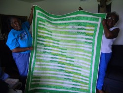 Women holding a quilt