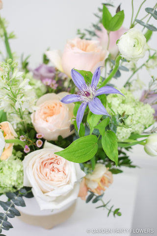 Pastel floral arrangement made with Juliet and White O'Hara garden roses, lavender clematis, local viburnum and eucalyptus.