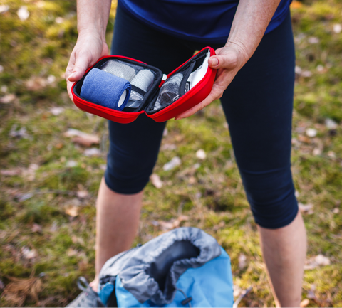 woman checks first aid kit