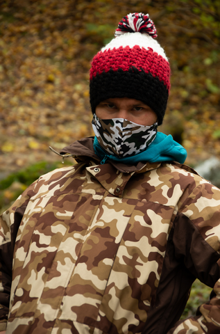Outdoor enthusiast wearing camouflage face mask and jacket