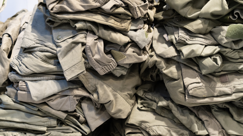 Pile of khaki green military clothing