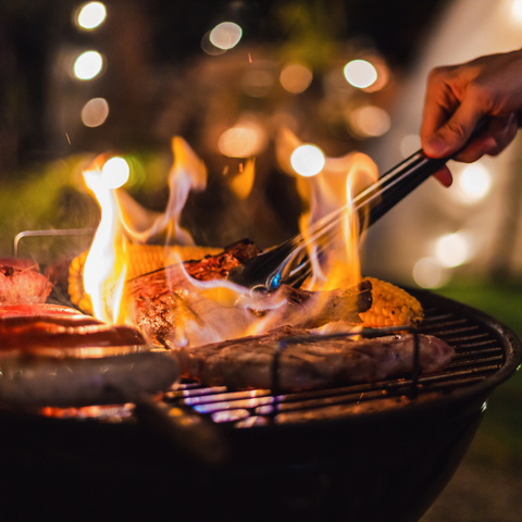 Barbeque full of food with large flames