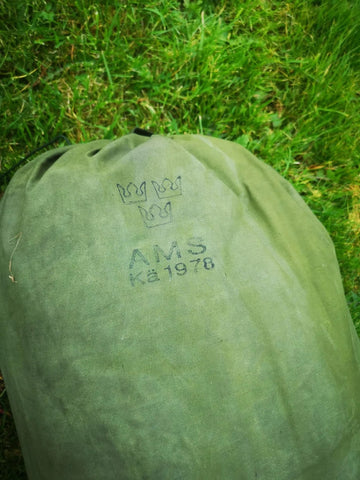 Close up of army tent tucked away in carry bag with three crown army stamp