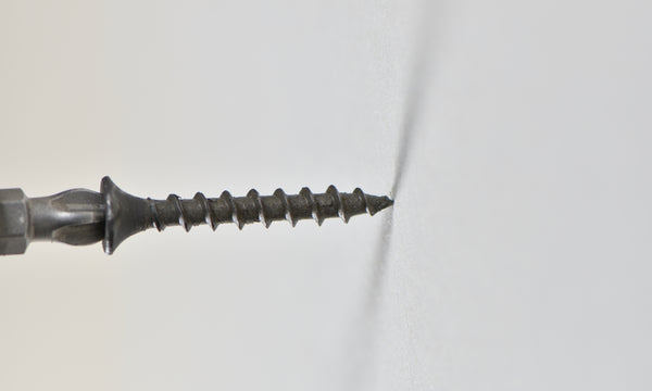 Drywall Screw being Drilled into Drywall