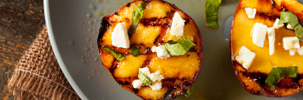 Grilled Peaches with Goat Cheese, Hot Honey, and Mint
