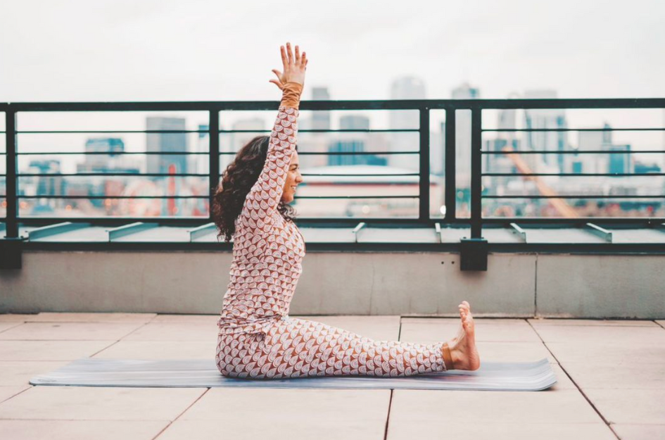 Woman demonstrating the first step of a forward fold yoga pose