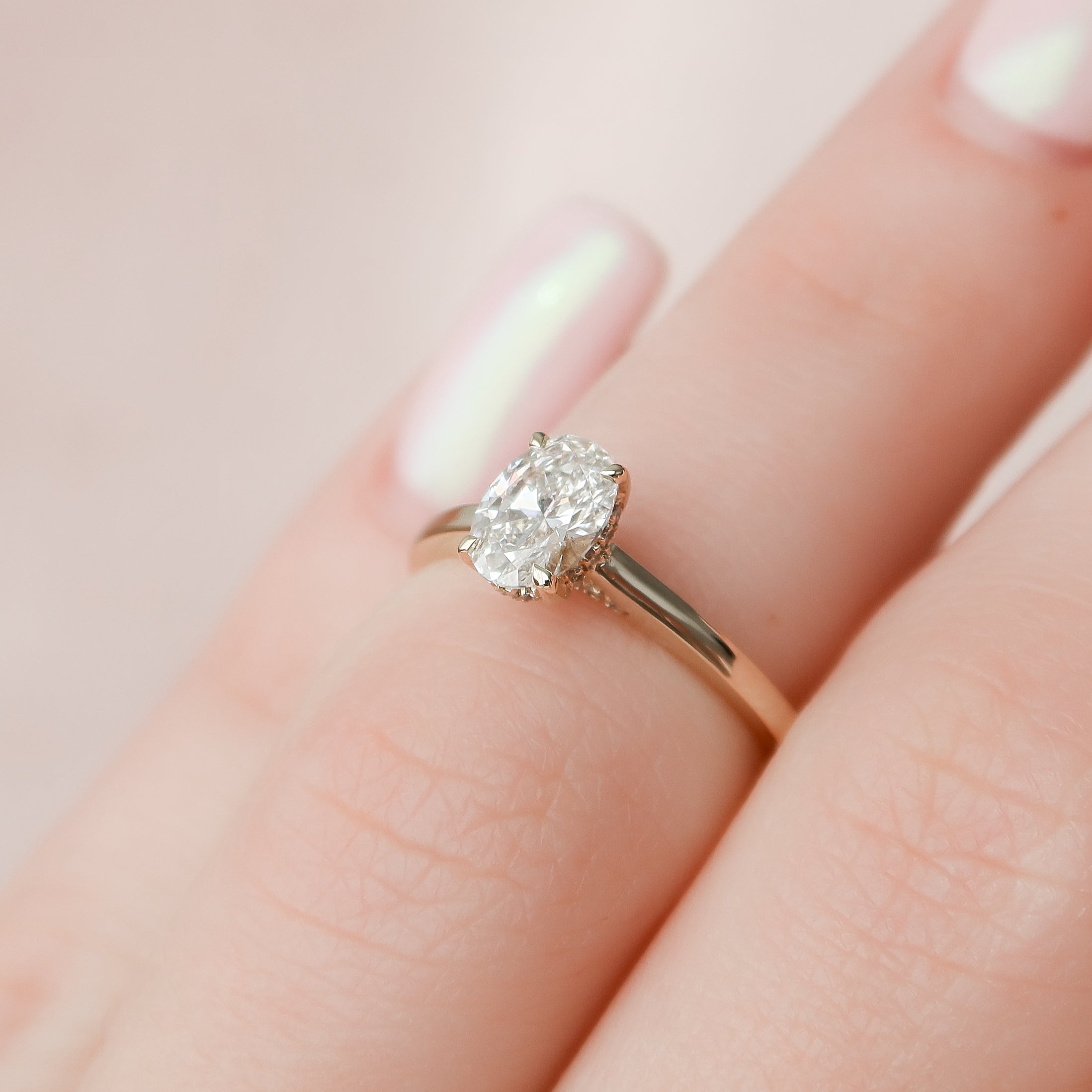 Oval Shaped Diamond Engagement Ring with Pear Shaped Diamonds on the side