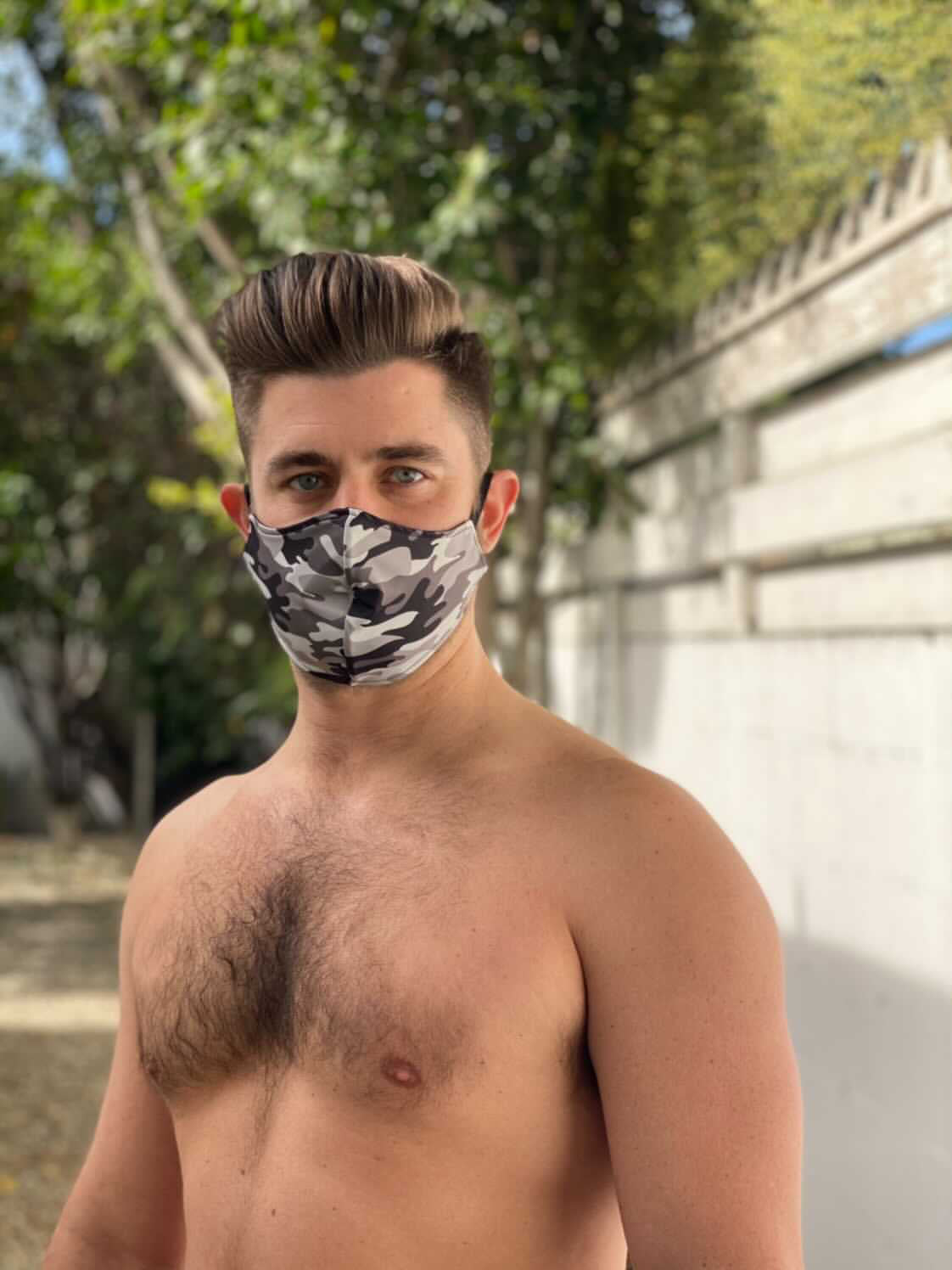 muscular male model wearing black camo mask