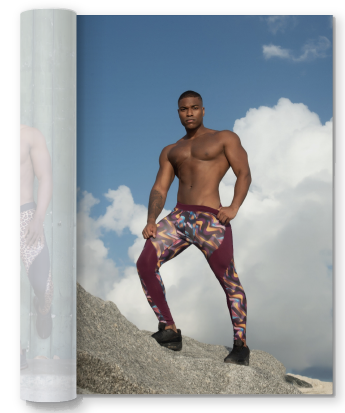 black man in neon red leggings posing on top of a mountain