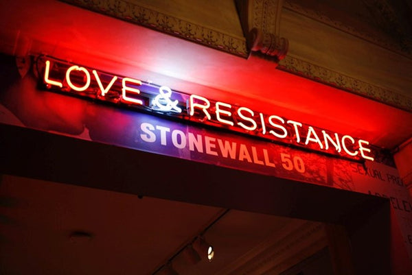 Storefront sign reading Love and Resistance