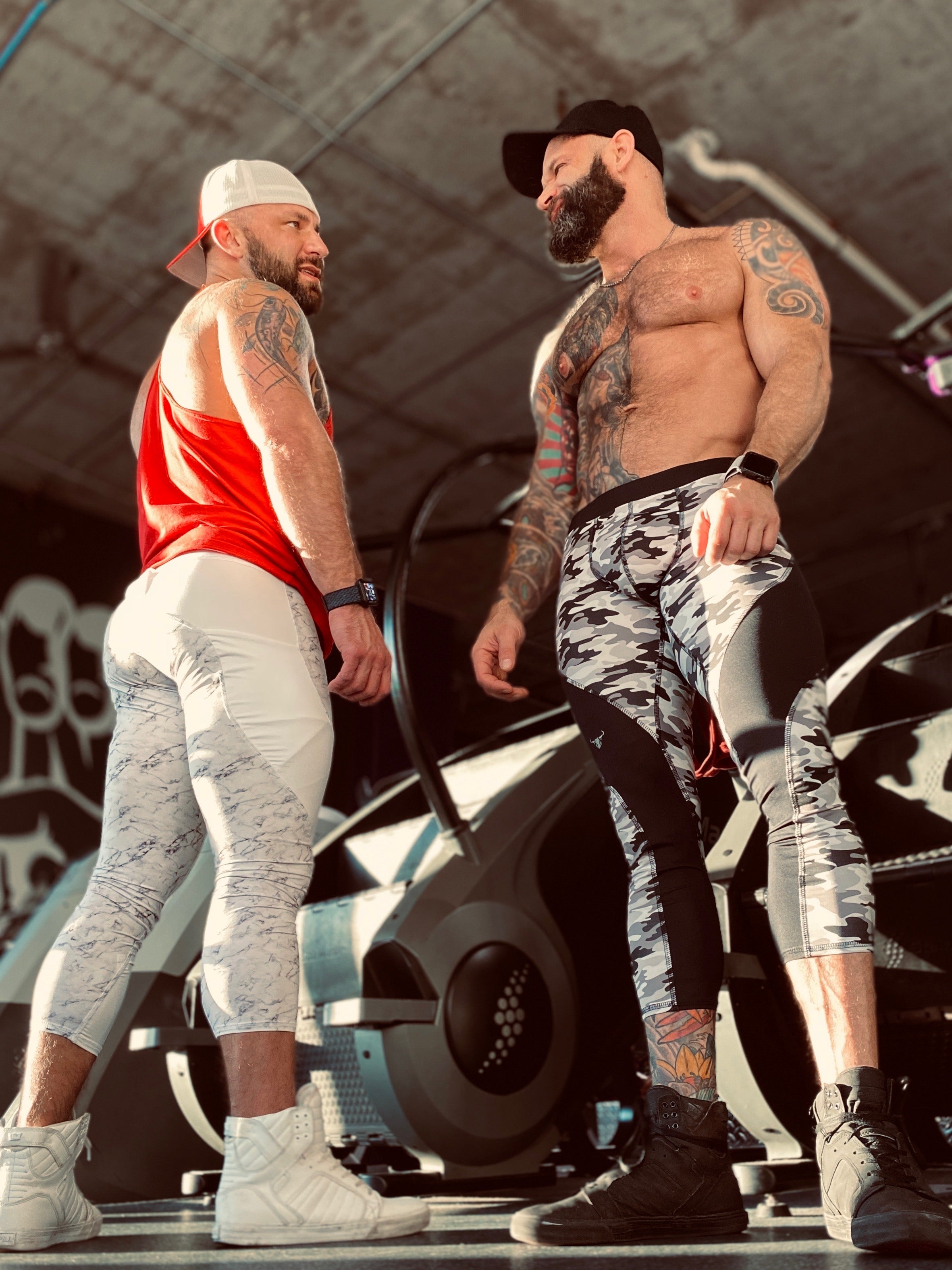 two men posing in Meggings at the gym