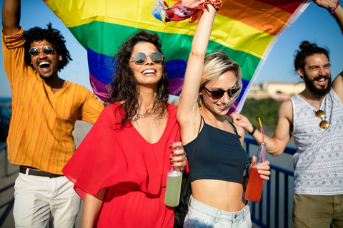 a group of people waving a gay pride flag
