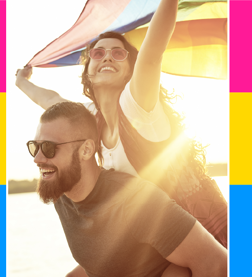 Couple waving LGBTQ flag