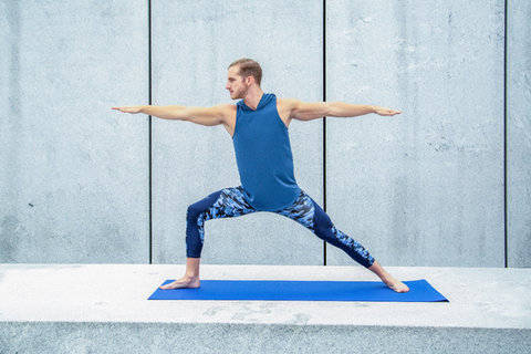 man performing yoga in the gym