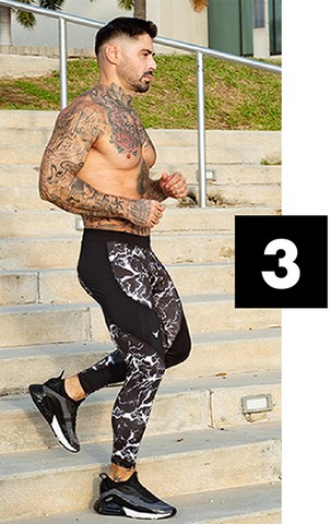 male model with tatoos wearing black men's compression leggings