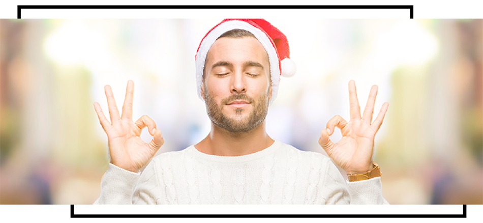 man in santa hat holding up two peace signs