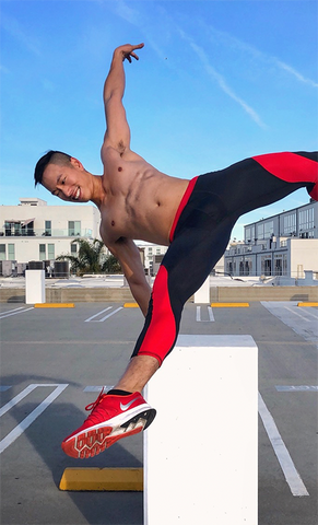 man performing parkour in red and black compression pants