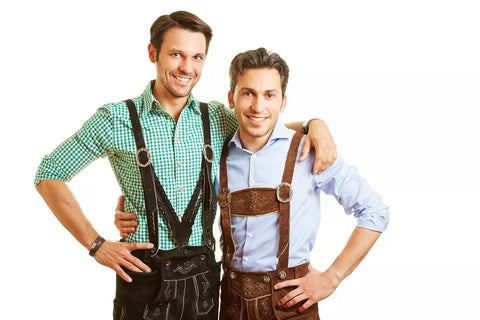 Two smiling bavarian men standing in leather pants