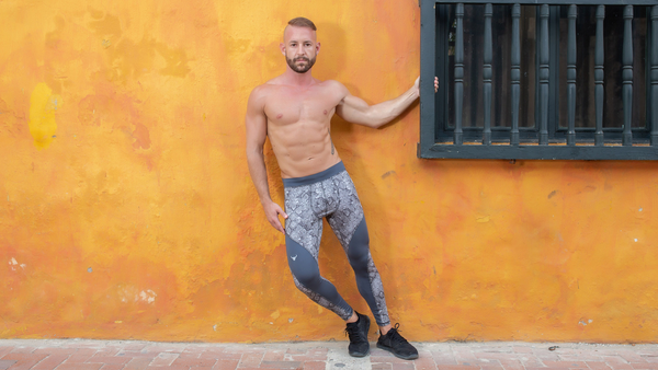 Valentine Aseyo outside of a building wearing grey stonewall leggings for men