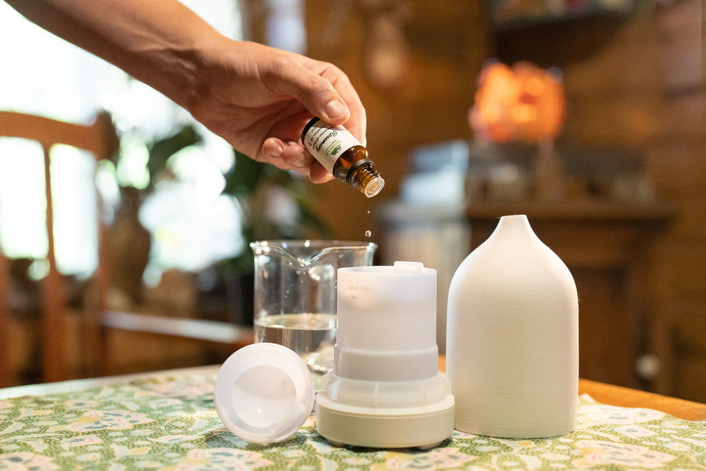 putting essential oil into a diffuser