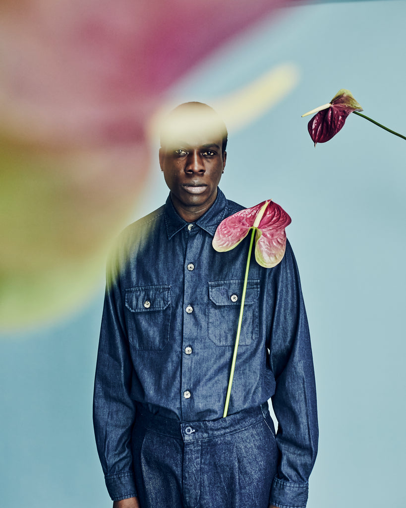 model in denim surrounded by florals