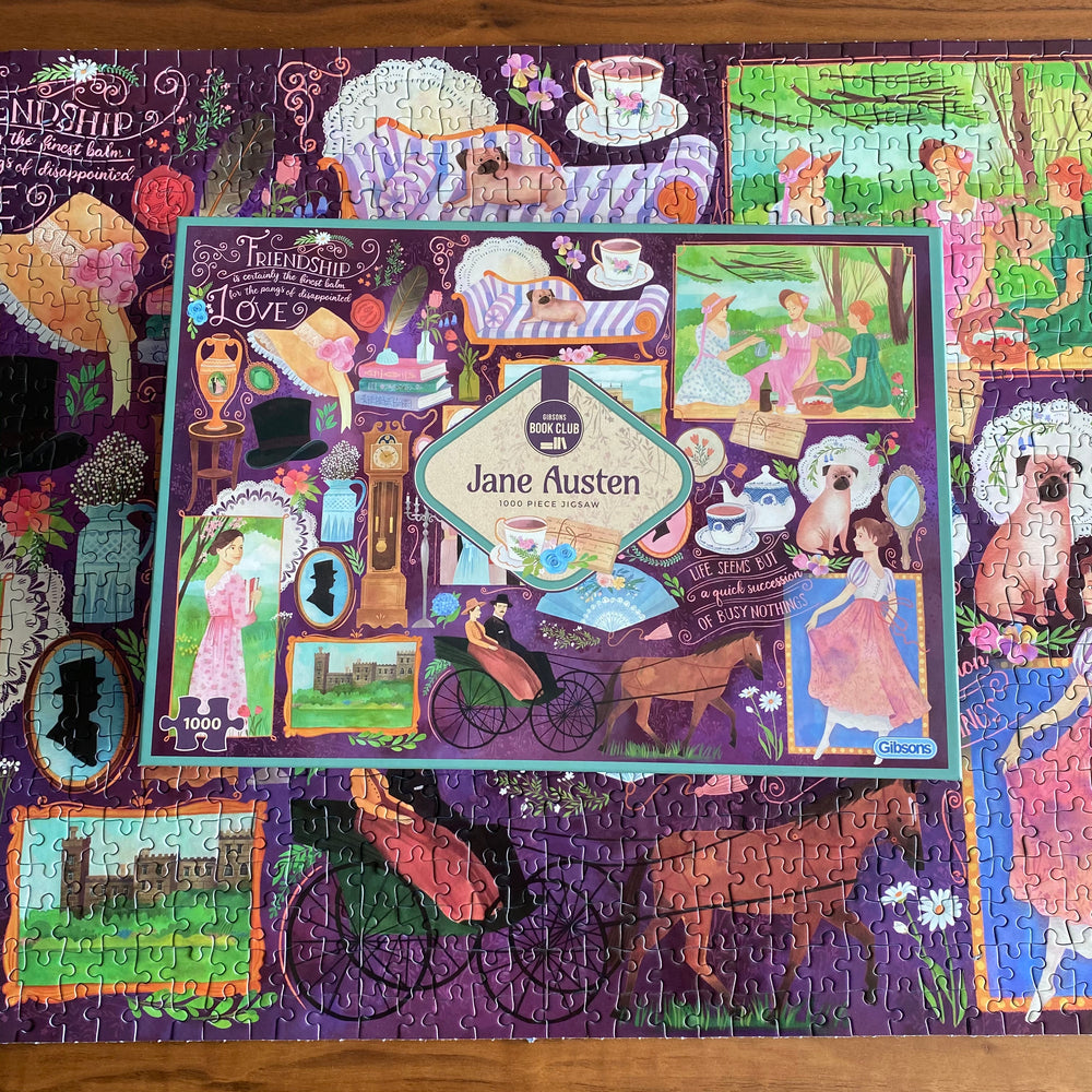 A collection of famous Jane Austen novels in the form of a jigsaw puzzle on a table.