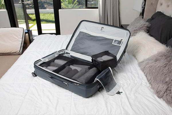 Image of open suitcase with bluetooth Tile tracker in pocket 