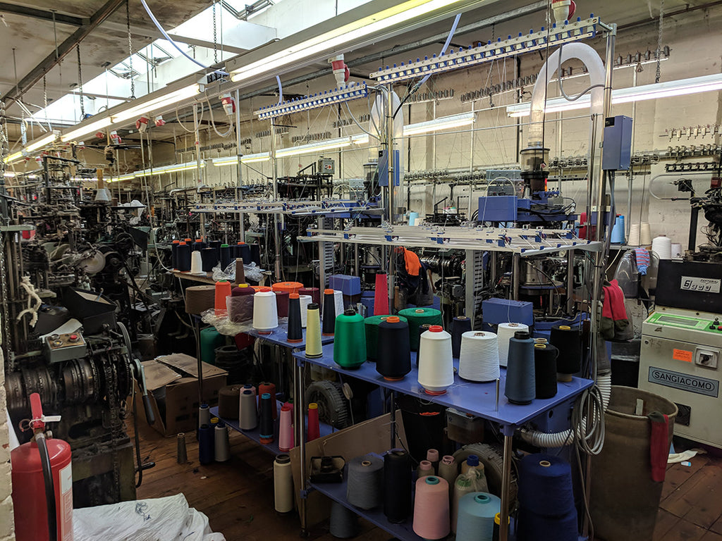 Looking across the factory at bobbins of yarn and machines