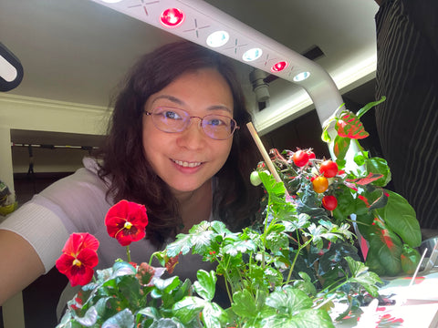 Indoor gardener smiling with the Smart Garden 9.