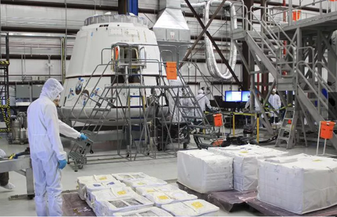 Bright orange FOD bags dispersed around a SpaceX Dragon cleanroom or hangar.  Photo courtesy of SpaceX.