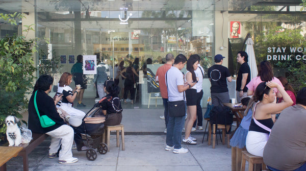 A crowd gathers outside the Plain Sight HQ during Lee Caces' artist reception