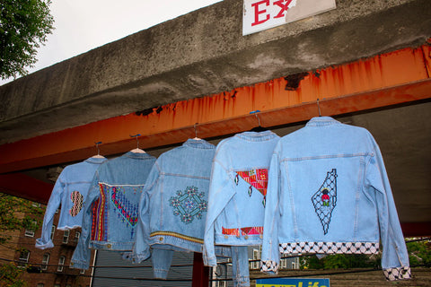 Denim jackets with traditional Palestinian Tatreez embroidery hanging