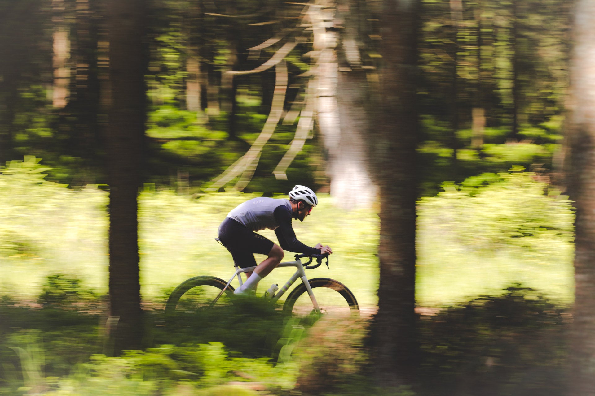 A gravel rider in the woods with Parcours FKT wheels and Panaracer GravelKing X1 tyres