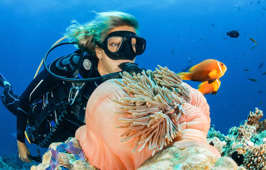 Girl Scuba diving on reef