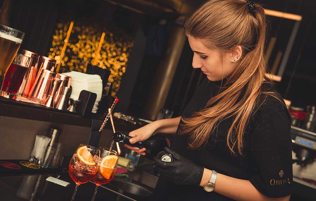 Girl pouring drinks in bar