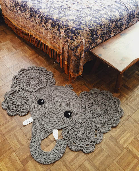 grey elephant face rug on the floor